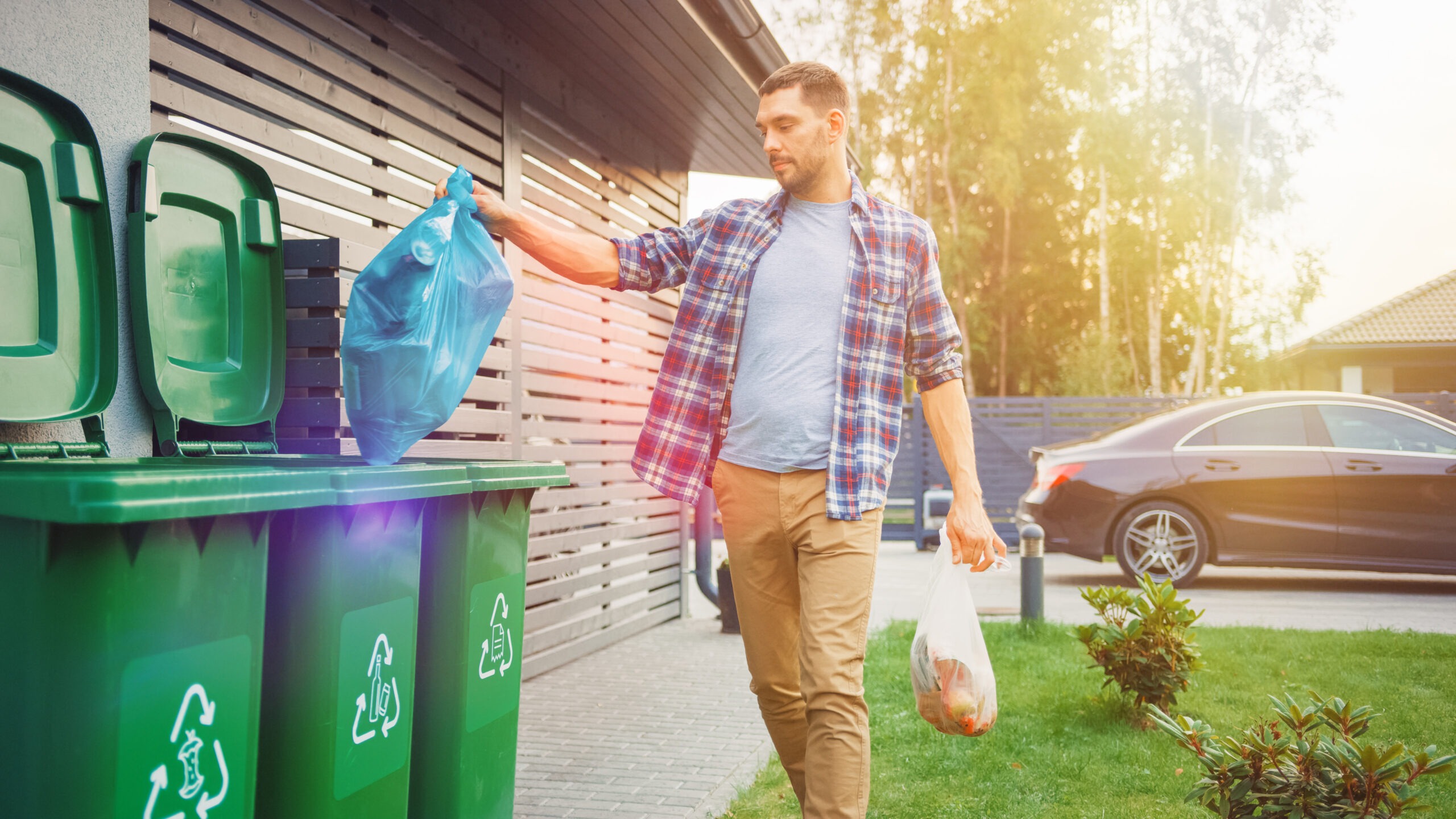 Caucasian,Man,Is,Throwing,Away,Two,Plastic,Bags,Of,Trash