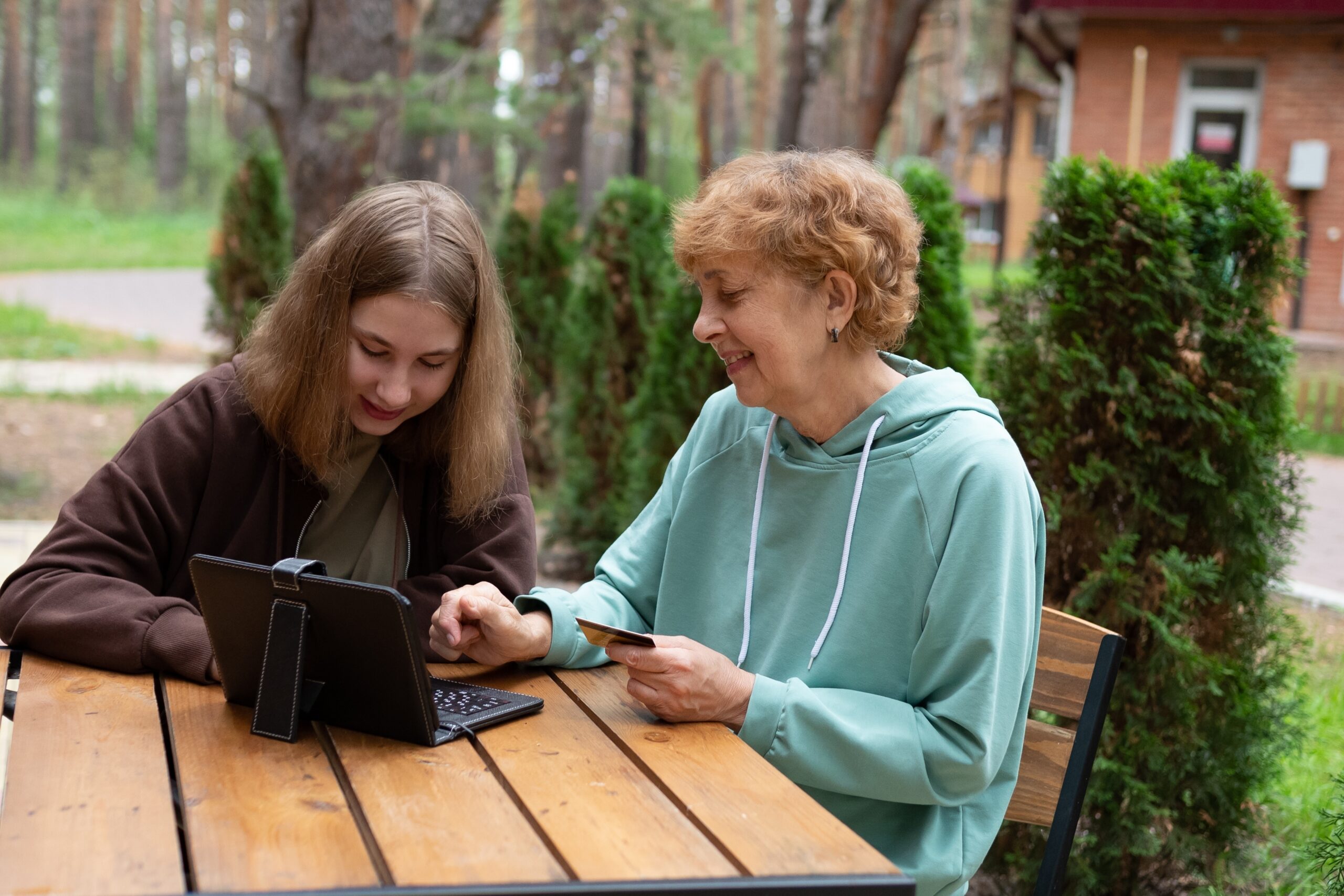 A,Happy,Mature,Grandmother,With,A,Granddaughter,Using,A,Credit